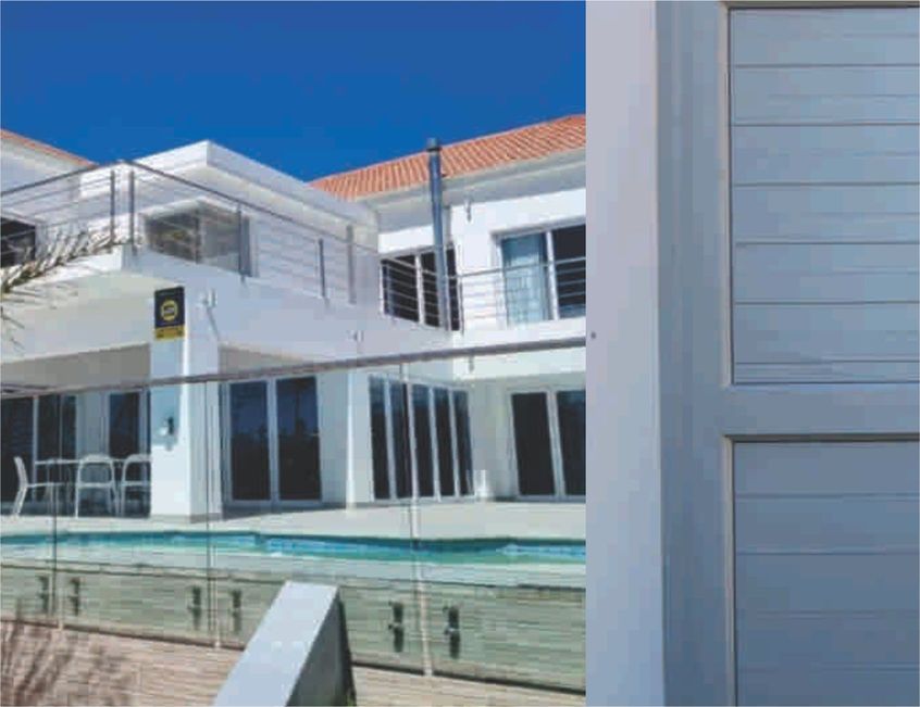 Glass and aluminium balustrades at a pool house by Prinro Aluminium