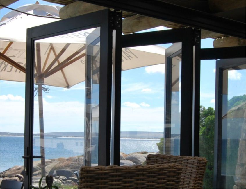 Aluminium stacker doors with a sea view by Prinro Aluminium